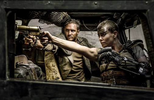 Tom Hardy as Max and Charlize Theron as Imperator Furiosa in the War Rig in Mad Max: Fury Road. 