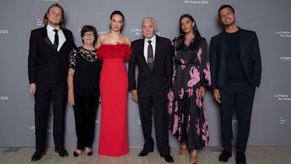 Family affair: Thea Anamara Perkins in red, flanked by her family at the Art Gallery of NSW on Tuesday. From left:  Thea’s partner Adam Finney, grandmother Eileen Perkins, Charles Madden (grandfather), sister Madeleine Madden and brother Tyson Perkins.