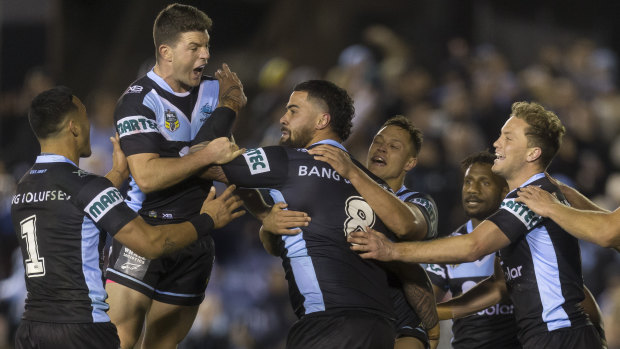 Attention elsewhere: Fifita is mobbed after scoring, but he shrugged off the attention to gesticulate wildly towards the coaches.