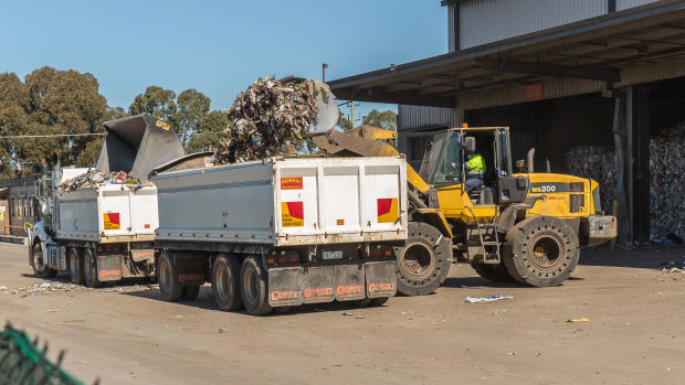 Recycling collected by councils and given to SKM was bulldozed into trucks and dumped at Ravenhall tip.