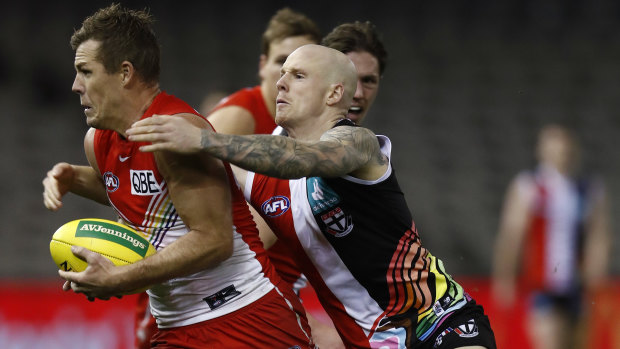 Zak Jones of the Saints tackles Luke Parker at Marvel Stadium. 