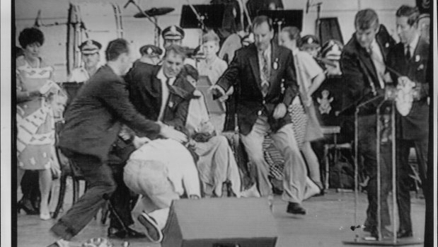 From left, a policeman, Mr. Fahey, and Mr. Kiernan rush to subdue the attacker as Prince Charles, right, is ushered away by a security man.
