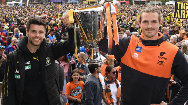Richmond's Trent Cotchin and GWS captain Phil Davis pose with the premiership cup on grand final eve.