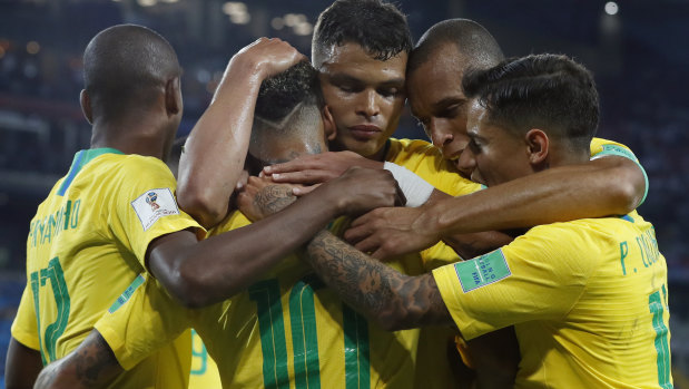 Together: Brazilian players embrace after Thiago Silva's goal.