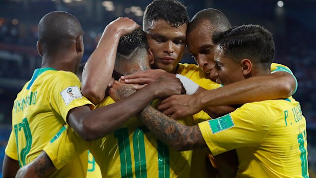 Together: Brazilian players embrace after Thiago Silva's goal.