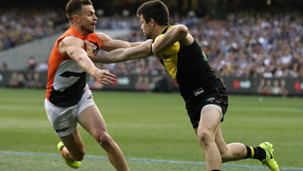 Deledio the Giant takes on old Tiger teammate Trent Cotchin.