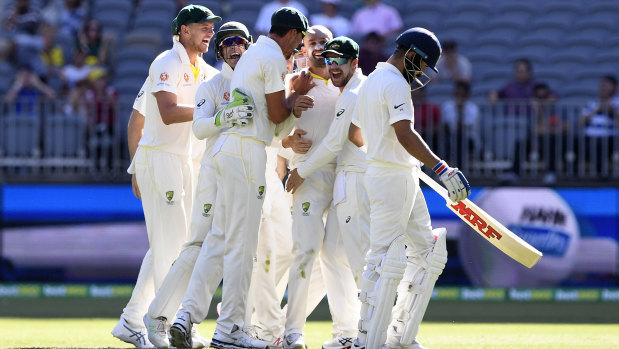 The Australians celebrate Virat Kohli's wicket.