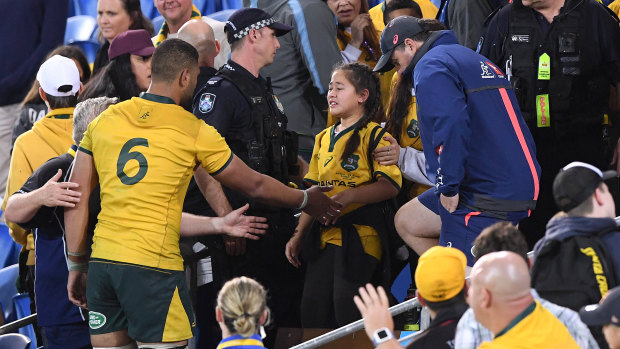 Unsavoury: Lukhan Tui consoles his sister after she was reportedly knocked over in the crowd.