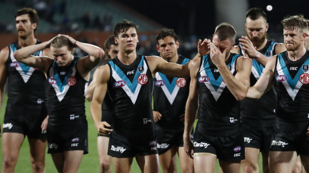 Port Adelaide players leave Adelaide Oval dejected on Friday night.