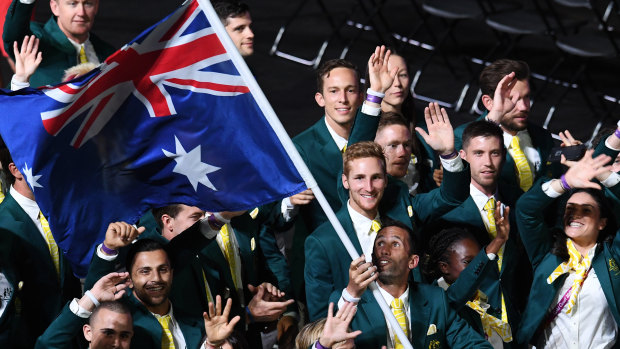 Flag bearer Mark Knowles leads the Australian team.