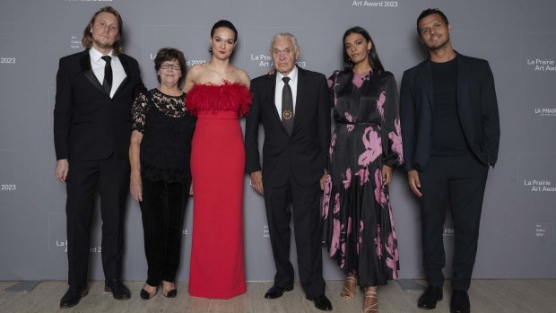 Family affair: Thea Anamara Perkins in red, flanked by her family at the Art Gallery of NSW on Tuesday. From left:  Thea’s partner Adam Finney, grandmother Eileen Perkins, Charles Madden (grandfather), sister Madeleine Madden and brother Tyson Perkins.