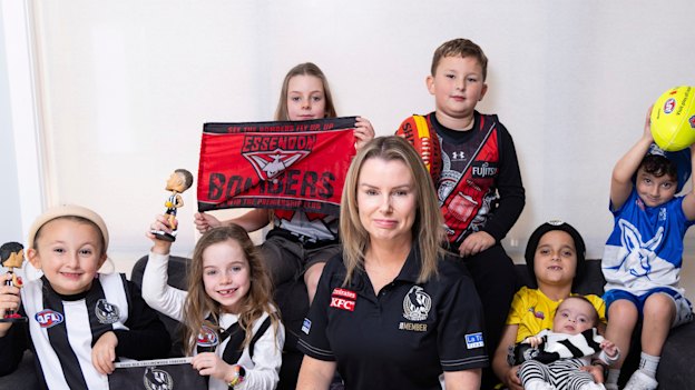 Casey Nunn with young football fans (from left) Molly, Chloe, Charlotte, Lachlan, Levi (holding baby Millie) and Andre.