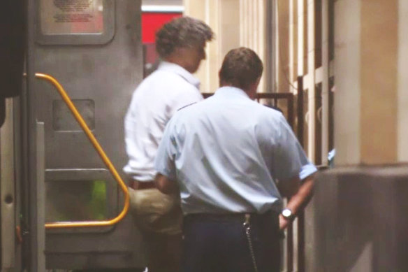 Adrian Basham is escorted into the Victorian Supreme Court building for his sentencing on Monday.