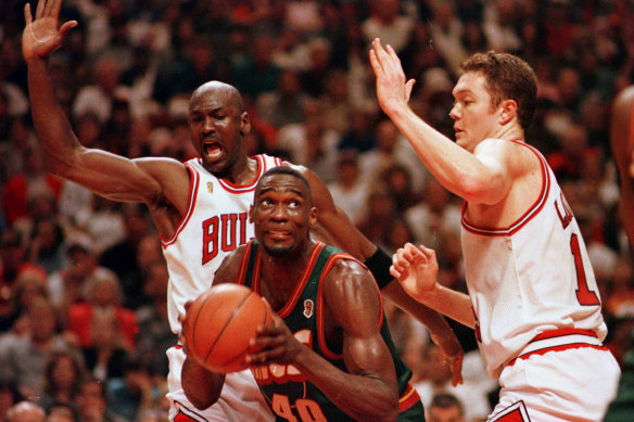 Chicago's Michael Jordan and Luc Longley defend Seattle's Shawn Kemp during game six of the NBA Finals in June 1996.
