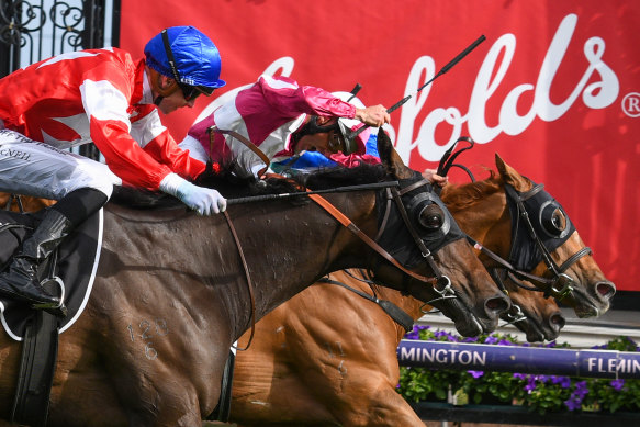 Damien Oliver, centre, en route to victory in the Kennedy Cantala during Derby Day. 