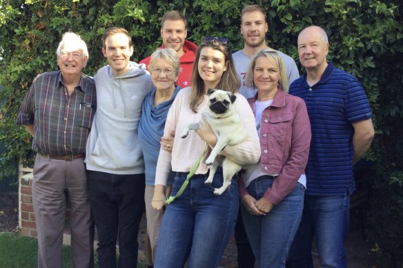 Harry and Ben McKay with the clan in 2021 (from left): grandfather Ian, brother Charlie, grandmother Val, Ben (in red), sister Hannah (holding Gina the dog), Harry, and parents Tracey and Peter.