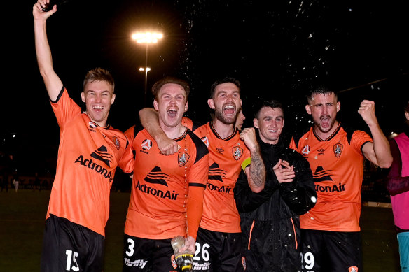 Corey Brown (second from left) celebrates a win over Perth Glory with teammates.