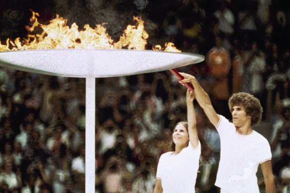 Gymnast Sandra Henderson, left, and track and field athlete Stéphane Préfontaine lighting the Olympic flame at the 1976 Montreal Olympics opening ceremony.