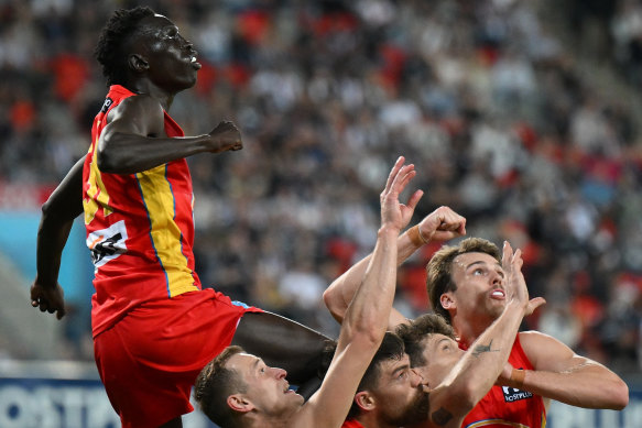 Mac Andrew of the Suns punches the ball clear.