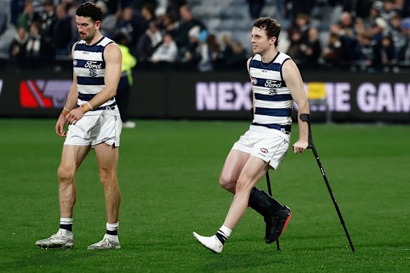 Max Holmes of the Cats is seen on crutches post game.