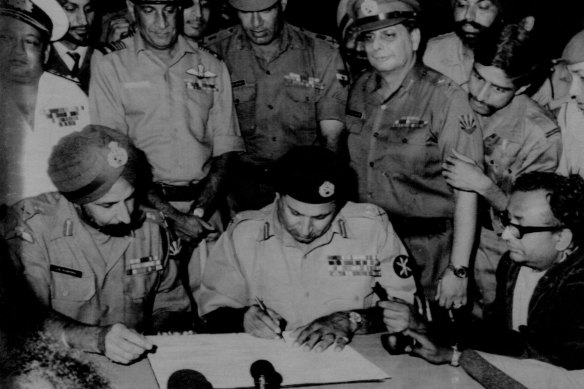 Lt. General A.A. K. Niazi (right) Pakistani (Seated second from left), signing the surrender document here today as Lt. General J.S. Aurora (left) Chief of India's eastern command, looks on. Other Pakistan and Indian army officers look on. December 16, 1971.