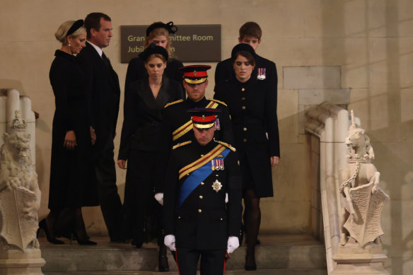 The Queen’s eight grandchildren enter Westminster Hall.