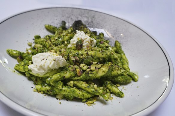 House-made strozzapreti with pesto topped with dollops of stracciatella. 