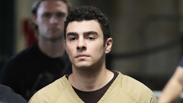 Luigi Mangione is escorted into Manhattan state court in New York.