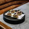Raw beef tartelettes with sour cream and caviar.