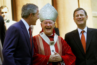 President George W Bush, left, laughs with McCarrick and Supreme Court Chief Justice John Roberts in 2005.