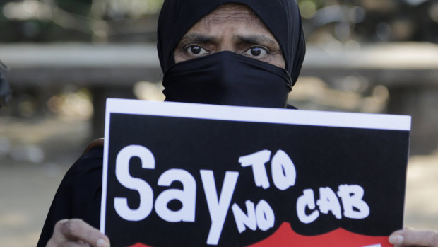An Indian woman holds a placard during a protest against Citizenship Amendment Bill (CAB) in Ahmadabad, India.