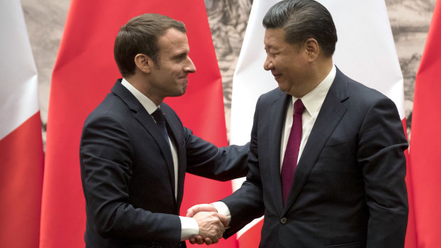 French President Emmanuel Macron, left, and Chinese President Xi Jinping shake hands in January.