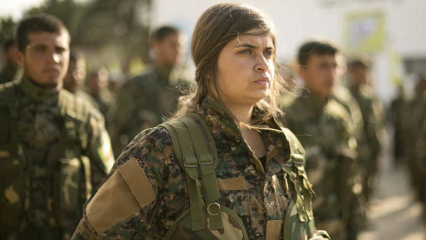 US-backed Syrian Democratic Forces stand in formation at a ceremony to mark their defeat of Islamic State militants in Baghouz.