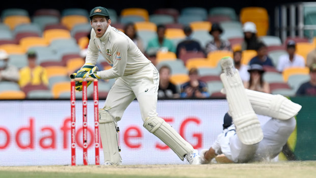 Tim Paine reacts as Cheteshwar Pujara of India makes his ground during day five of the fourth Test in the series between Australia and India at the Gabba in January.