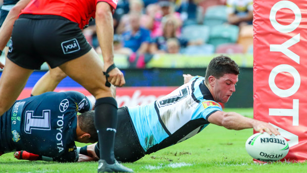 Stretch: Chad Townsend reaches out to open the try-scoring for the Sharks in Townsville.