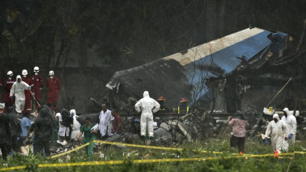 Rescue teams search through the wreckage site of a Boeing 737 that plummeted into a cassava field with more than 100 passengers on board, in Havana, Cuba.
