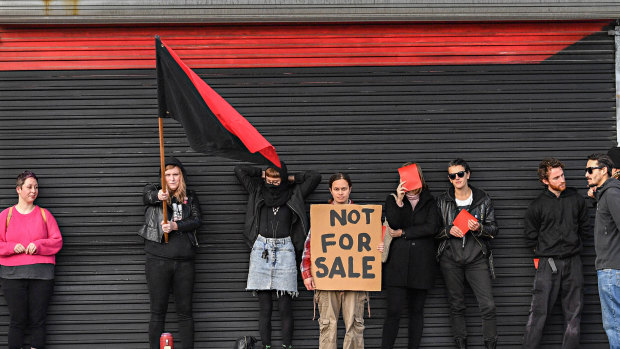 Melbourne Anarchist Club members protest outside the clubhouse during an open for inspection on Saturday afternoon.