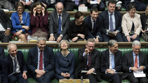 Theresa May has a quiet chuckle at it all.