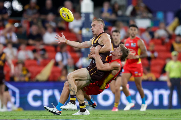 James Worpel of the Hawks is tackled by Will Graham of the Suns.