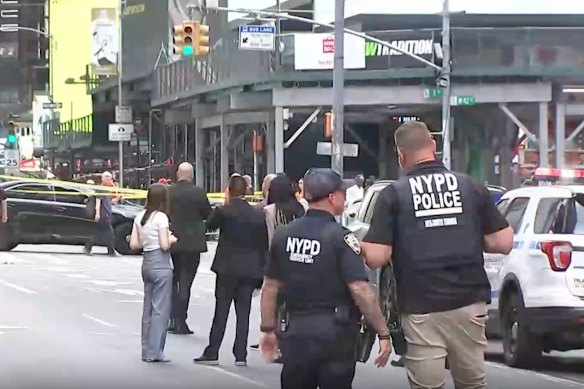 This image made from video provided by WABC shows NYPD officers on the scene after a woman brandishing two large knives was shot by officers in Times Square.