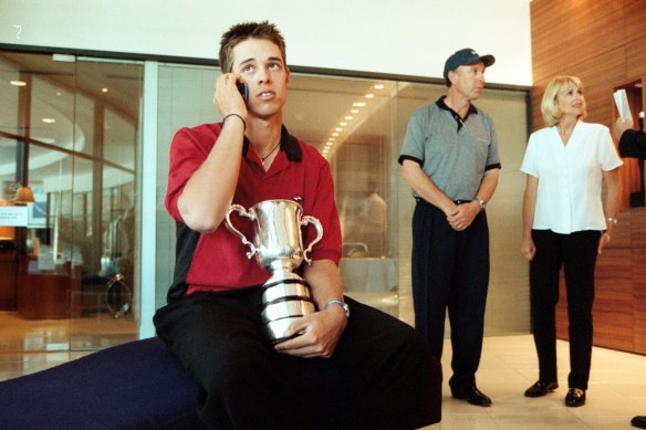 Aaron Baddeley doing an interview in his hotel foyer after winning the 1999 Australian Open, with parents Ron and Jo-Ann in the background.