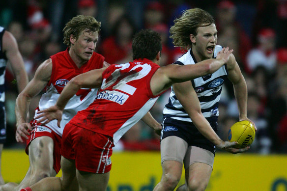 Geelong’s Gary Ablett avoids Sydney’s Amon Buchanan.