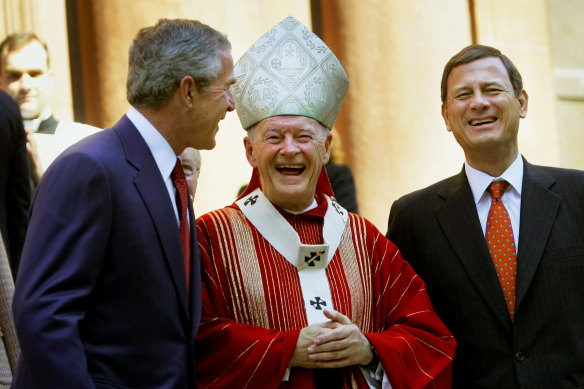 President George W Bush (left) laughs with McCarrick and Supreme Court Chief Justice John Roberts in 2005.