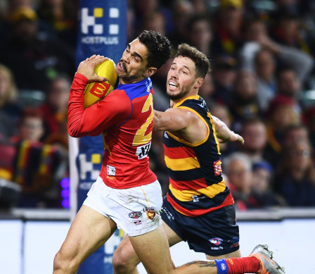 Charlie Cameron marks in front of Brodie Smith.