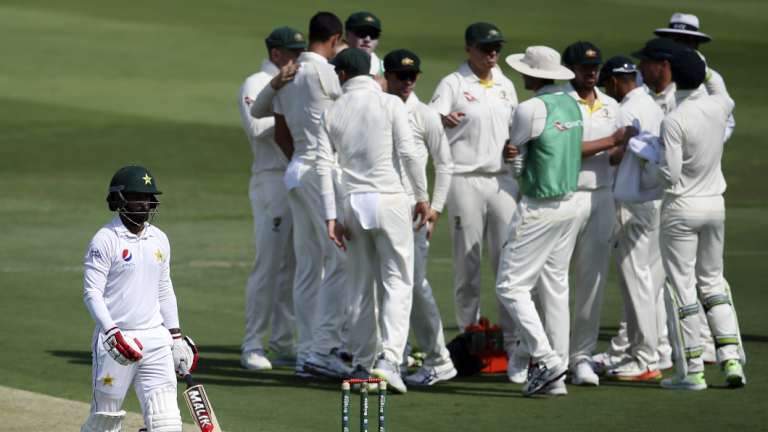 Muhammad Hafeez heads back to the stands yesterday as Pakistan host Australia in the UAE. 