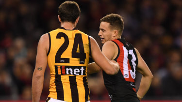 Claws out: Hawk Ben Stratton gives Bomber Orazio Fantasia a nip during the round 13 match at Marvel Stadium in Melbourne.