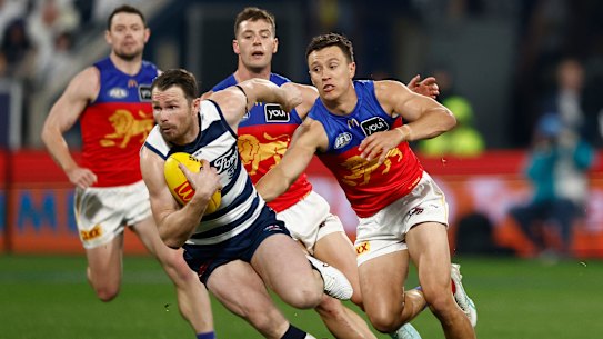 Lions star Hugh McCluggage gives chase to Geelong captain Patrick Dangerfield.
