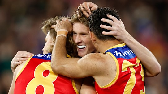 Will Ashcroft, Jaspa Fletcher and Charlie Cameron celebrate for the Lions.