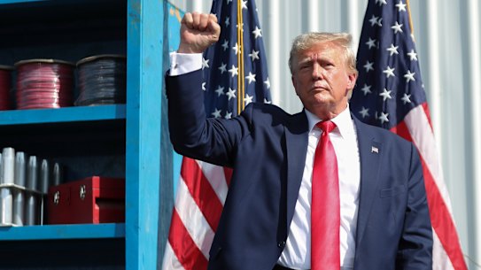 Former President Donald Trump ends his remarks and holds up his fist at a rally in South Carolina. 