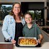 Kenmore residents Rebekah and Tex Treloar volunteer for a charity making lasagne for those in need. 